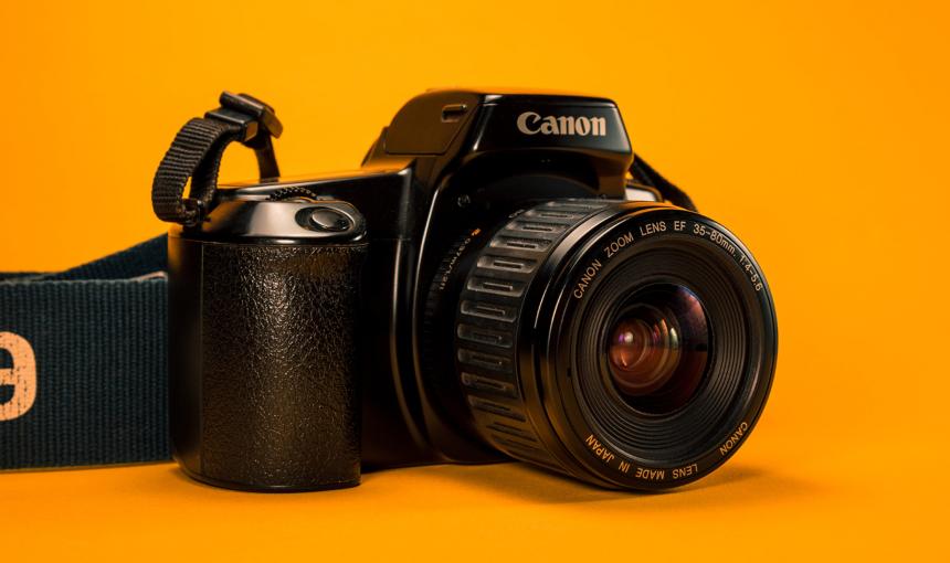 An image of a camera on a yellow background