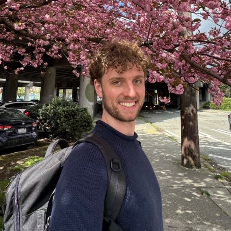 Image of Lars standing in front of cherry blossoms