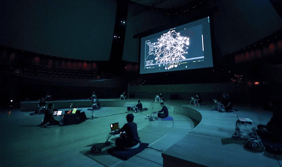 dark room with people using laptops