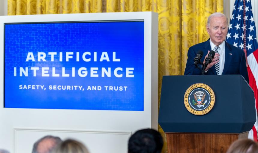 President Biden standing at a podium, announcing the new AI executive order