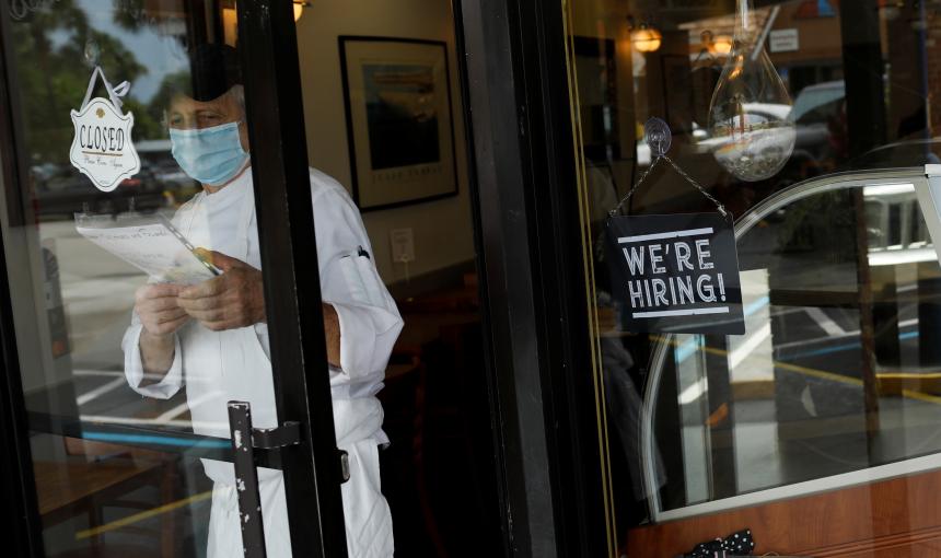 A mask-wearing worker opens a restaurant in Miami. 