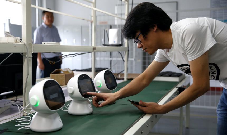 An engineer tests a "Xiaoyi" robot, a Siri-like voice assistant, which links the user to Lanchuang's intelligent elderly care system, at the headquarters of Lanchuang Network Technology Corp in Weifang, Shandong province, China, July 25, 2019.