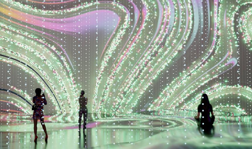 Wavy shaped art displayed on a large digital screen in a room
