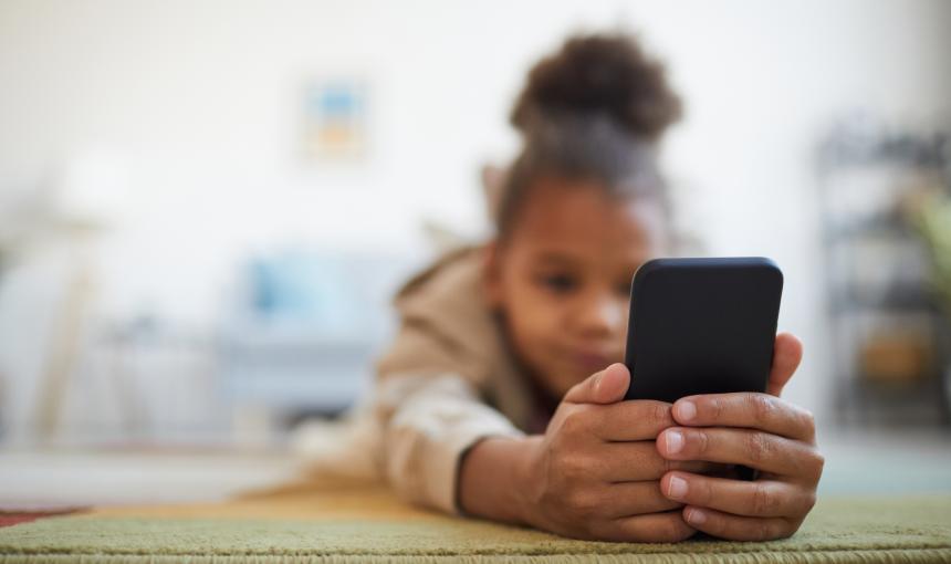 A child plays on her cell phone