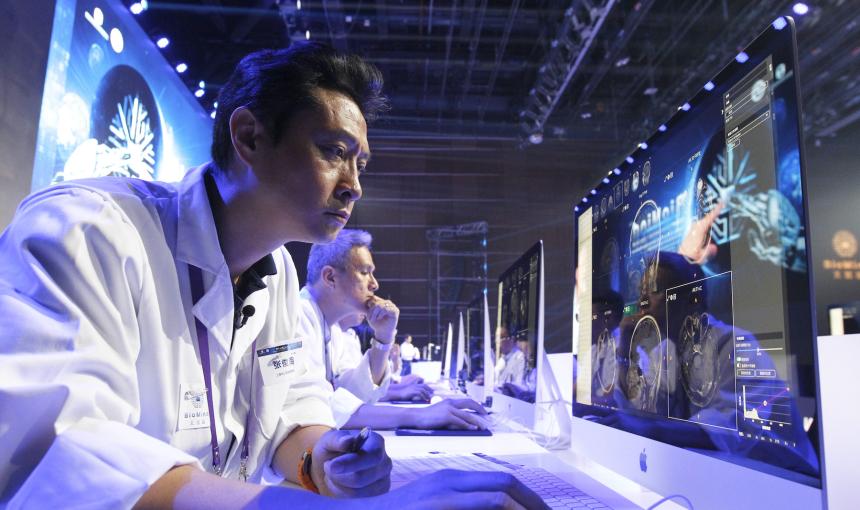 A doctor examines medical images on a screen. 