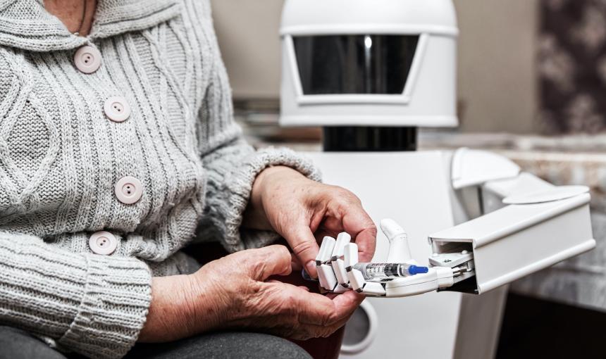 autonomous caregiver robot is holding a insulin syringe, giving it to an senior adult woman in her living room
