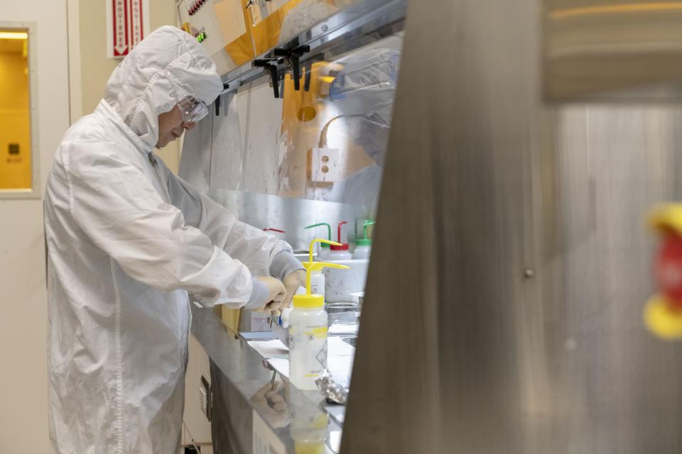 A lab technician works at the solvent bench to clean his wafer in a nanotechnology lab at a Stanford nanofabrication facility