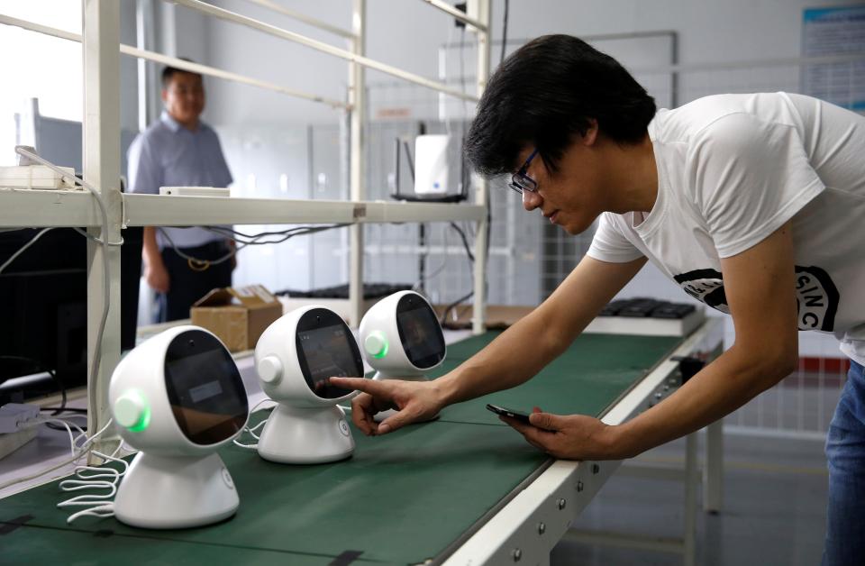 An engineer tests a "Xiaoyi" robot, a Siri-like voice assistant, which links the user to Lanchuang's intelligent elderly care system, at the headquarters of Lanchuang Network Technology Corp in Weifang, Shandong province, China, July 25, 2019. 