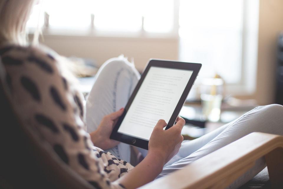 Woman reads on a kindle