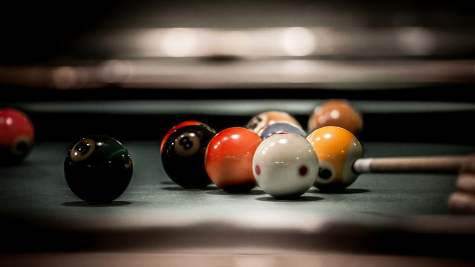 Billiard balls mildly scattered in a pool table