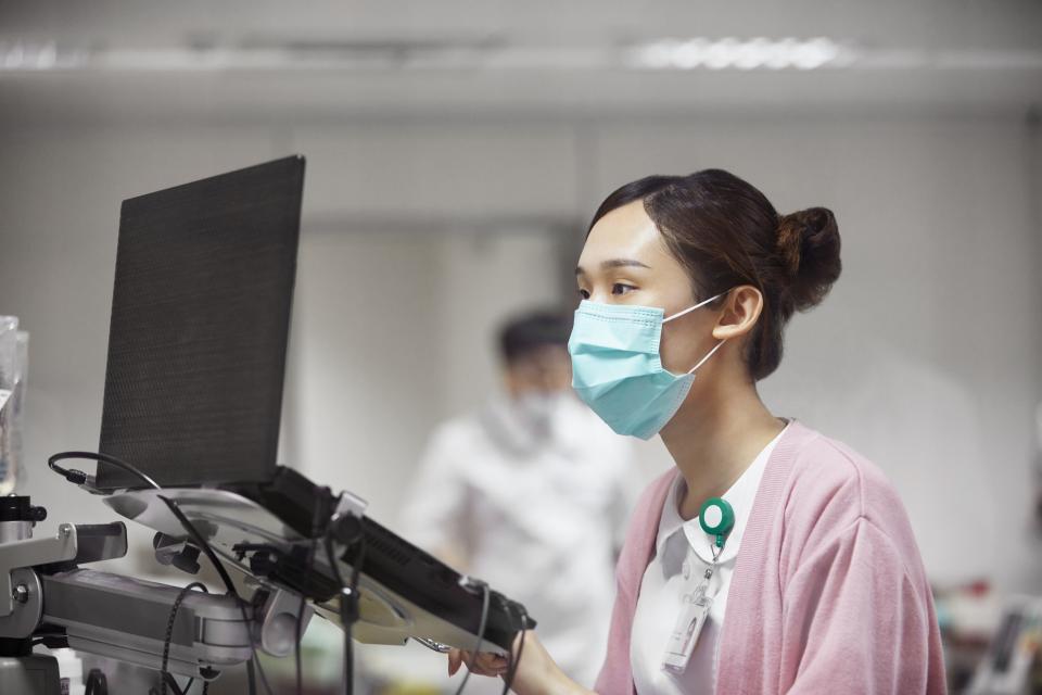 A nurse using a laptop while making a medical record. Healthcare worker is concentrating while working in laboratory. 