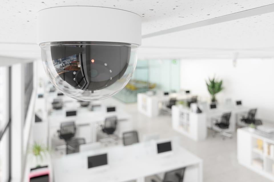 CCTV Camera In Open Plan Blurry Office