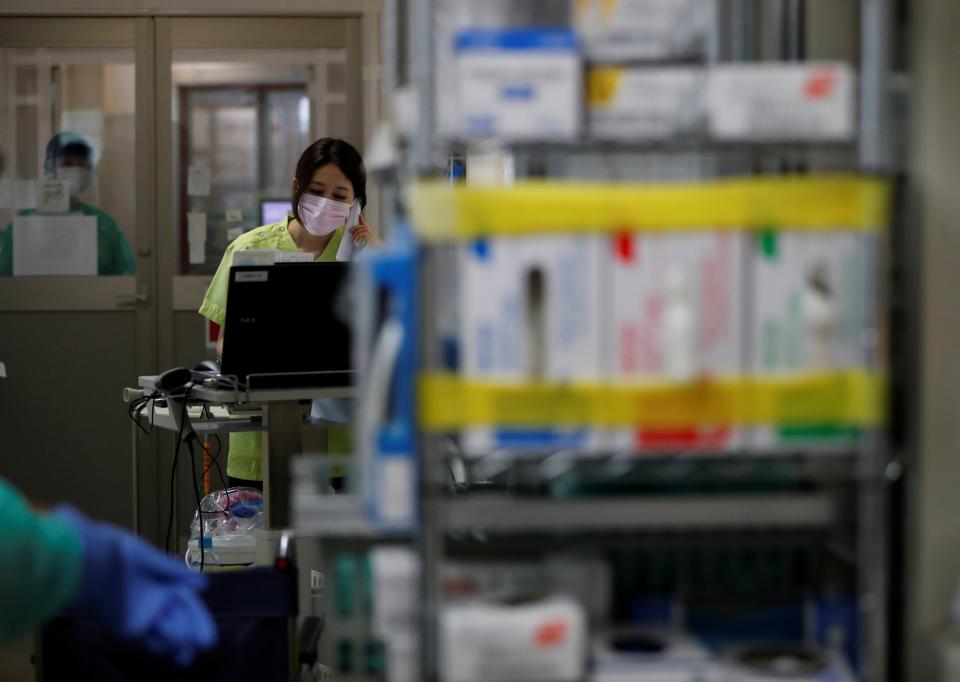 A medical worker stands at a computer inside the Intensive Care Unit (ICU) ward at St. Marianna University Yokohama Seibu Hospital 