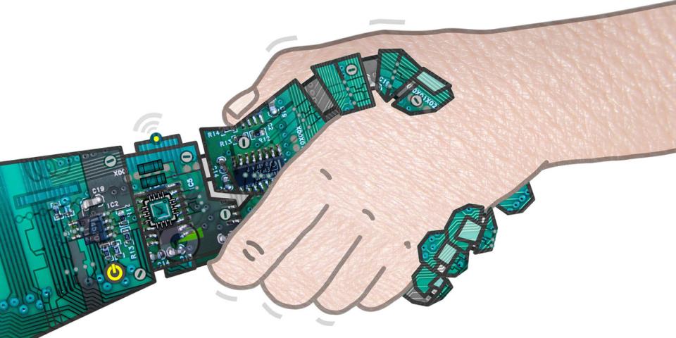 A robot hand and a human hand shake