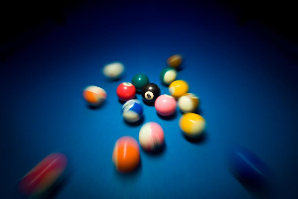 Fast moving billiard balls on blue table