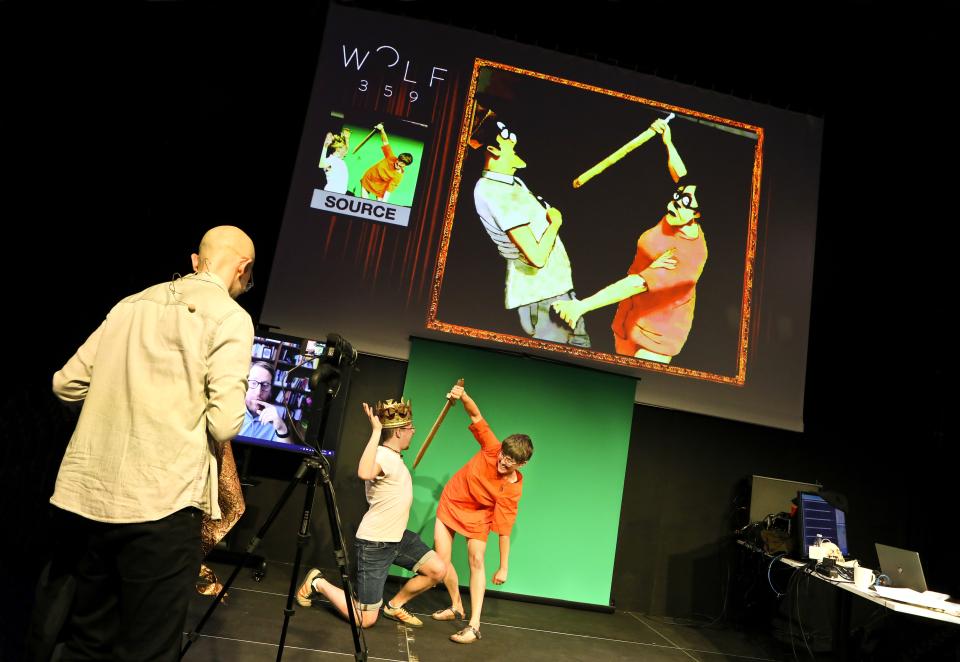 On stage, actors depict a sword-fight scene while an AI mimics their movements.