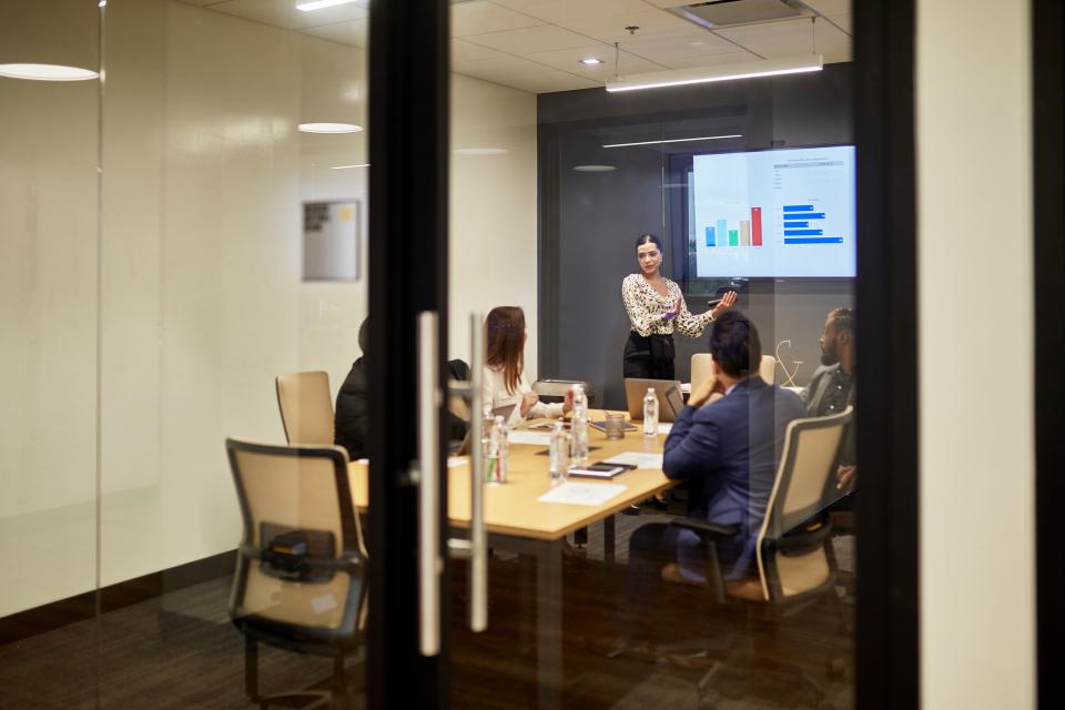 corporate board room in discussion over charts