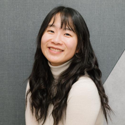 headshot wearing white sweater