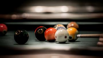 Billiard balls mildly scattered in a pool table